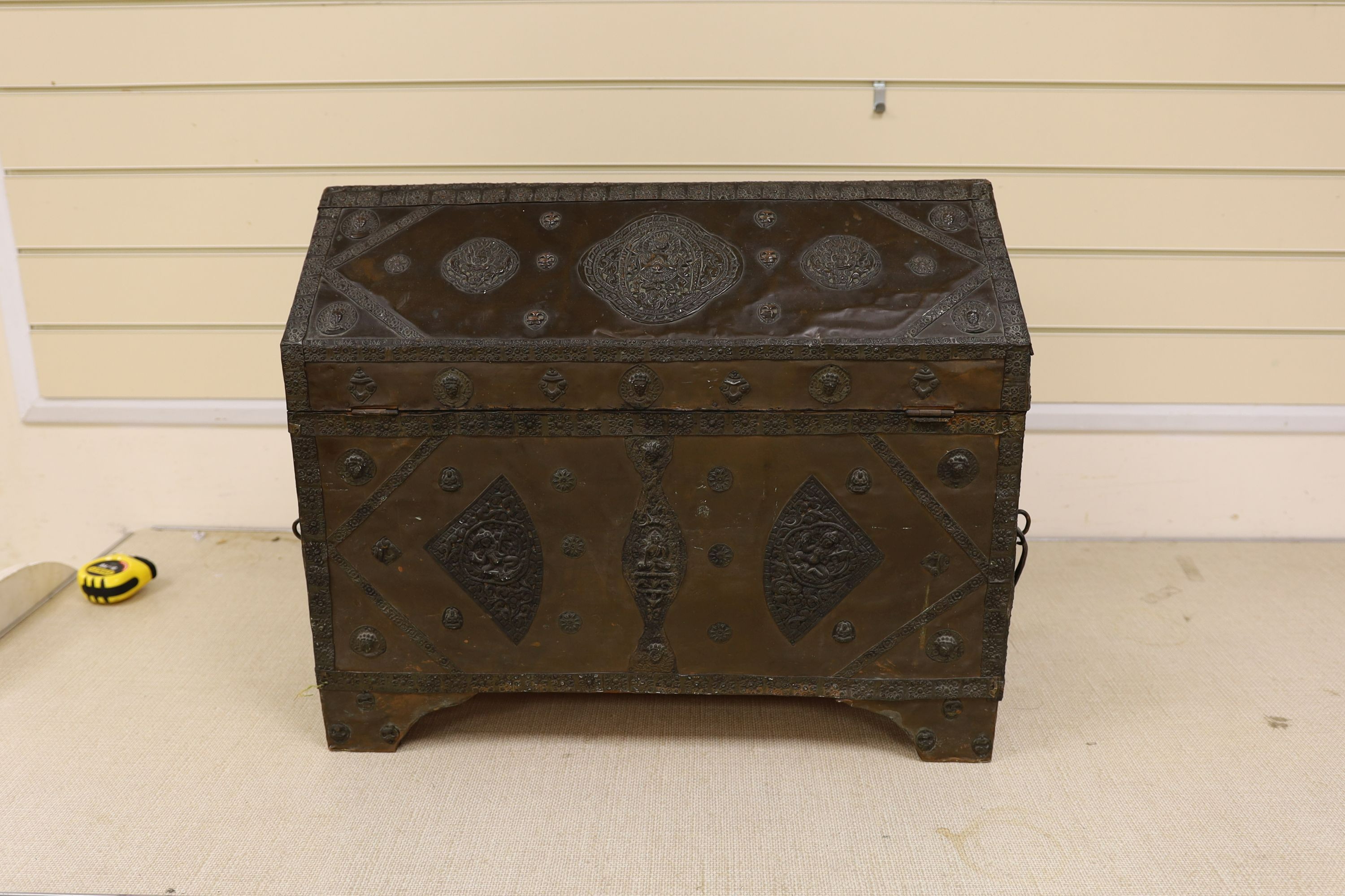 A Tibetan copper repousse-work casket, 20th century, 65cm wide, 49.5cm